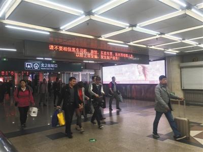 昨日，北京西站北2出口处，电子显示屏不停地播放提醒公告。本版摄影/新京报记者 王飞